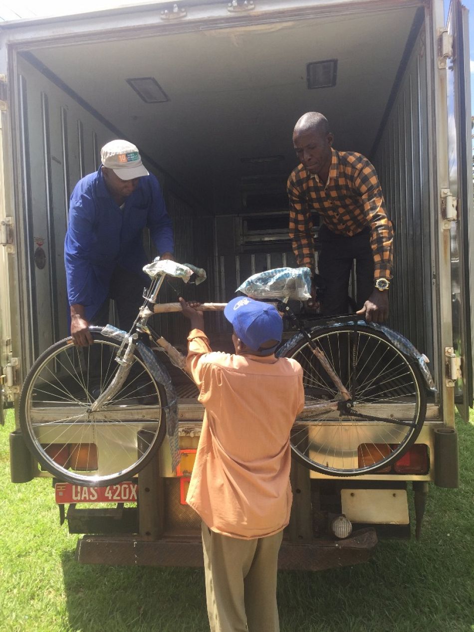 pThe last bicycle is unloaded in Iyolwa as the members of villages health teams begin to arrive to collect their new bicyclep