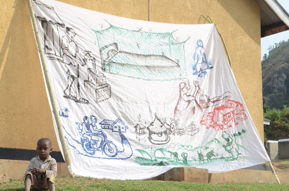 pThe communities create murals and paintings demonstrating what they have learnt This is a painting that was on display in the village demonstrating mosquito net use keeping stagnant water away from the village and showing the benefits of the boda boda hospital referral systemp