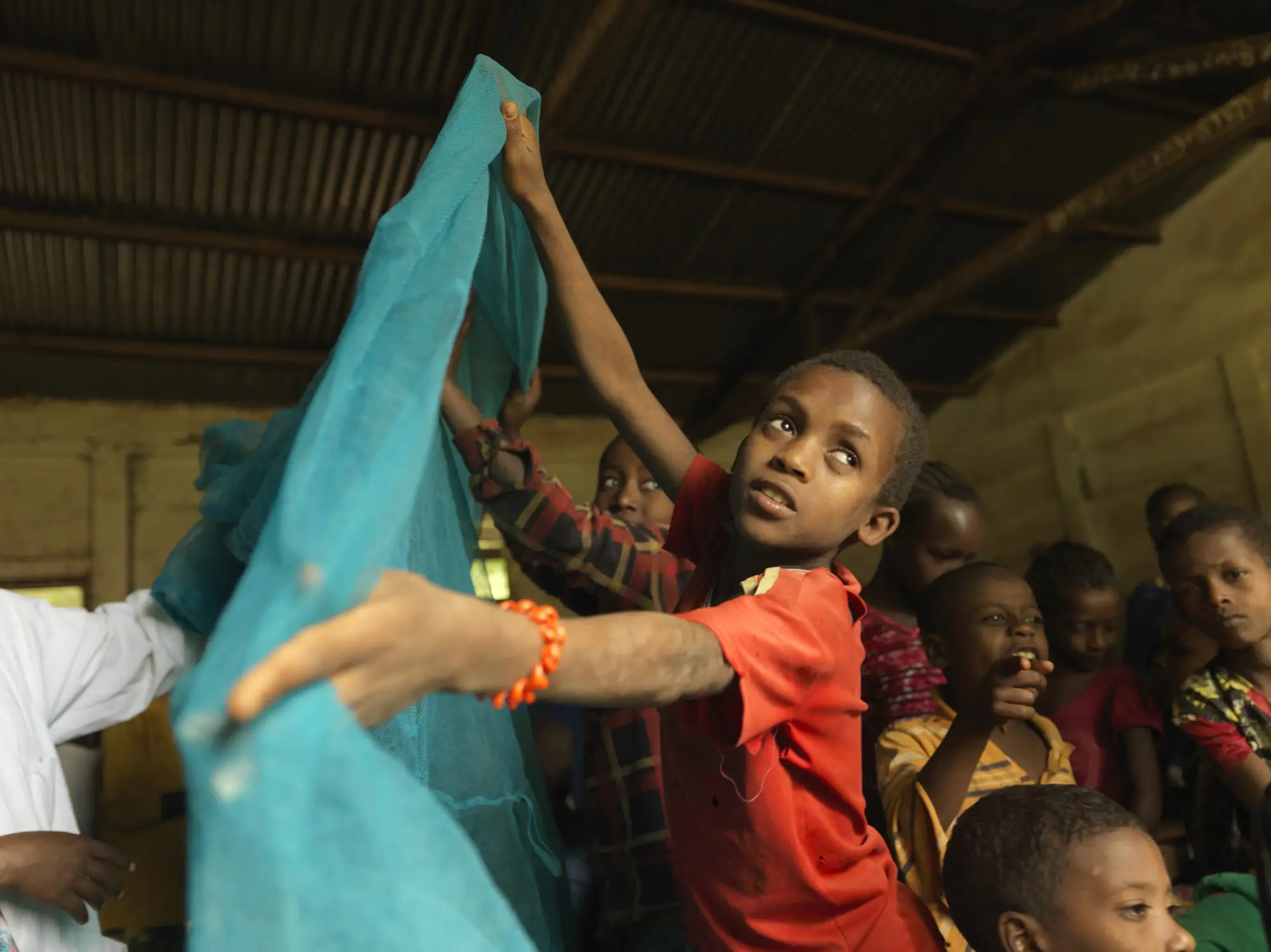 Children are taught about the benefits of using a mozquito net at Himbecho Primary School, Ethiopia.
