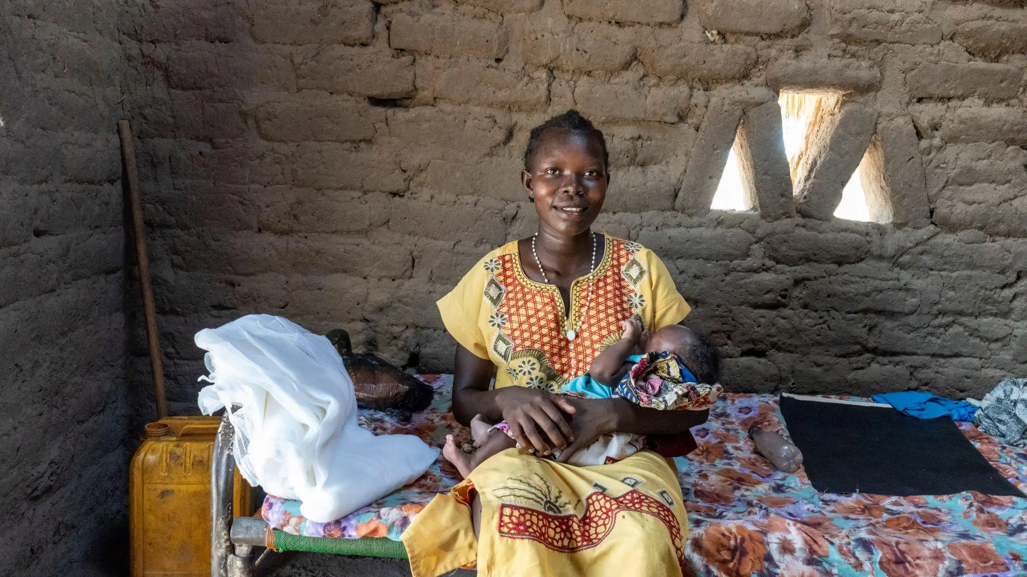 Athou, mother of newborn, receives a long-lasting insecticidal net (LLIN) as part of distribution campaign in Aweil West, South Sudan, April 2023