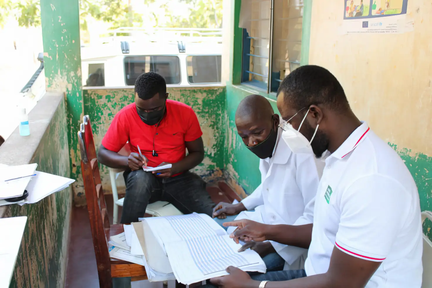 Three healthcare workers perform data quality assessment in Mecanhelas District in Niassa at Sales Health Unit in Mozambique