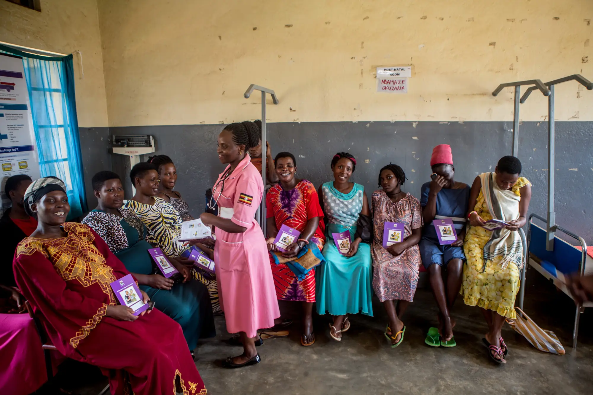 A community worker talks to female community members in Masaka, Uganda in 2019