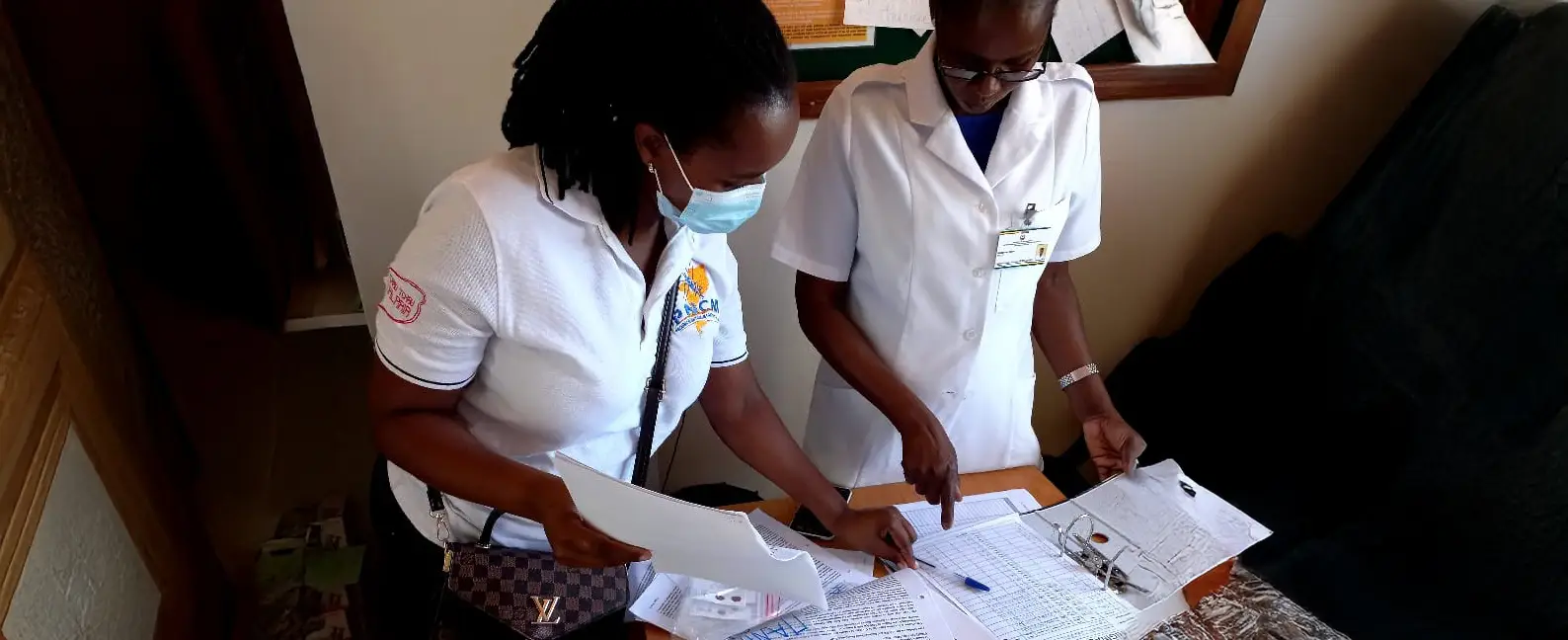 Two healthcare workers log data as part of the GenMoz programme in Mozambique