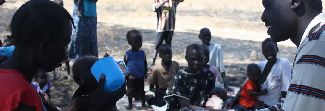 201512160938 27 aknot aleu wol and child akuol piol dengvisting community otp cnw simon deng garrang gives plumpy nut hong village aweil west s sudan dec 2012