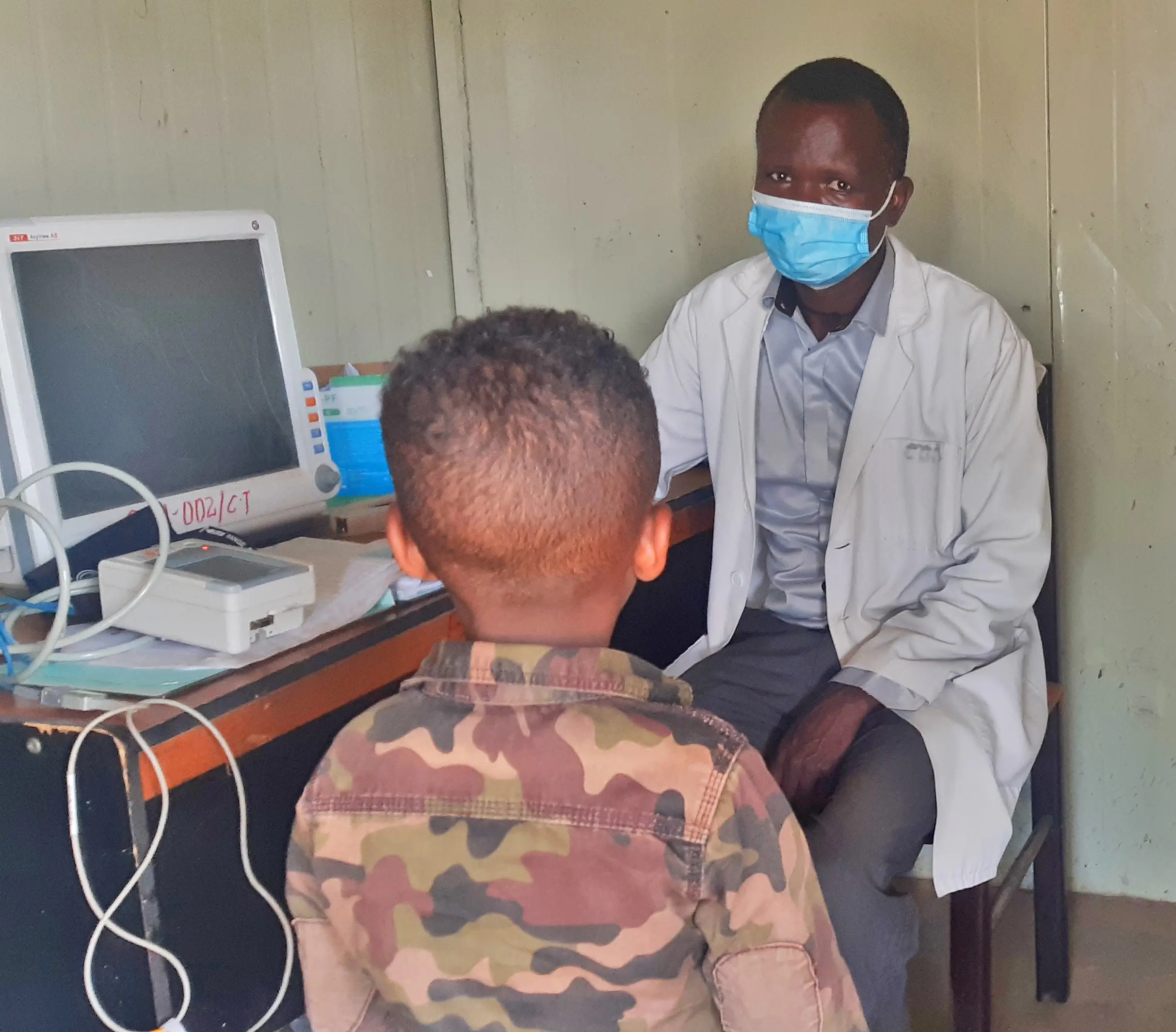 A healthcare worker attends to a young boy as part of work tackling NTDs in Ethiopia
