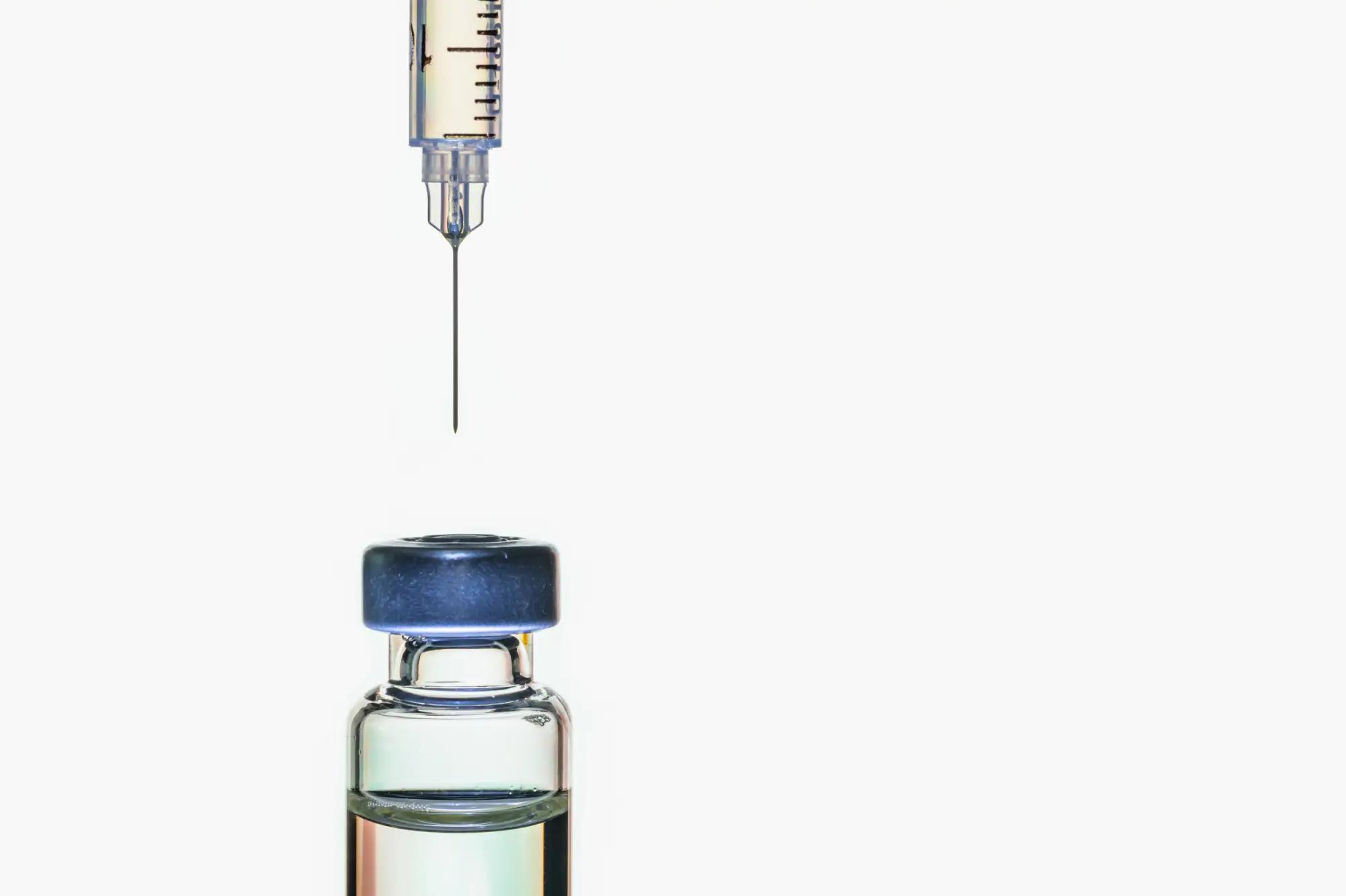 Needle going into a bottle of medication