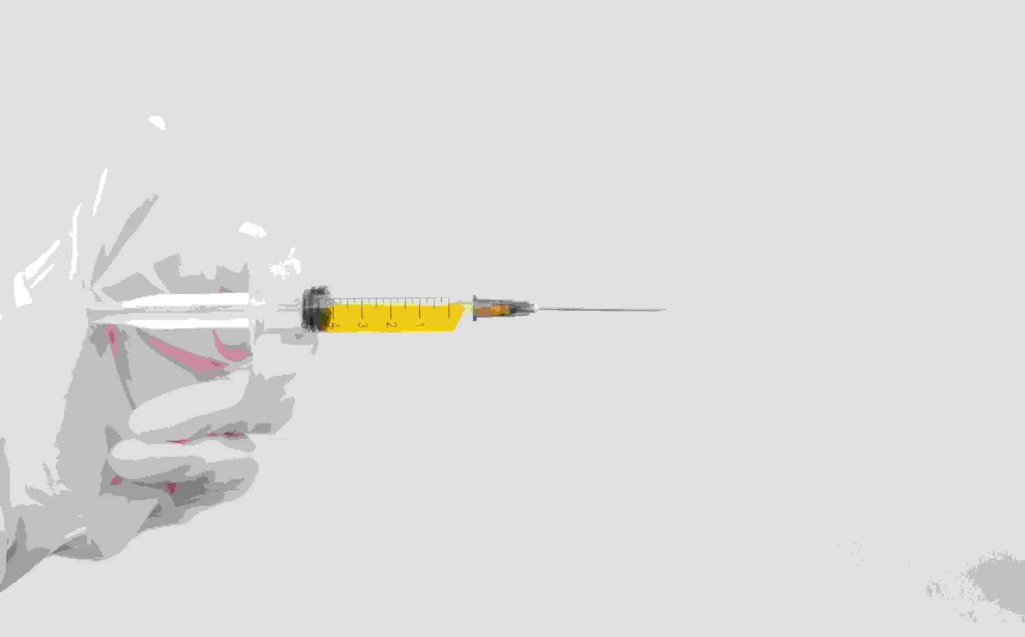 Gloved hand holding needle