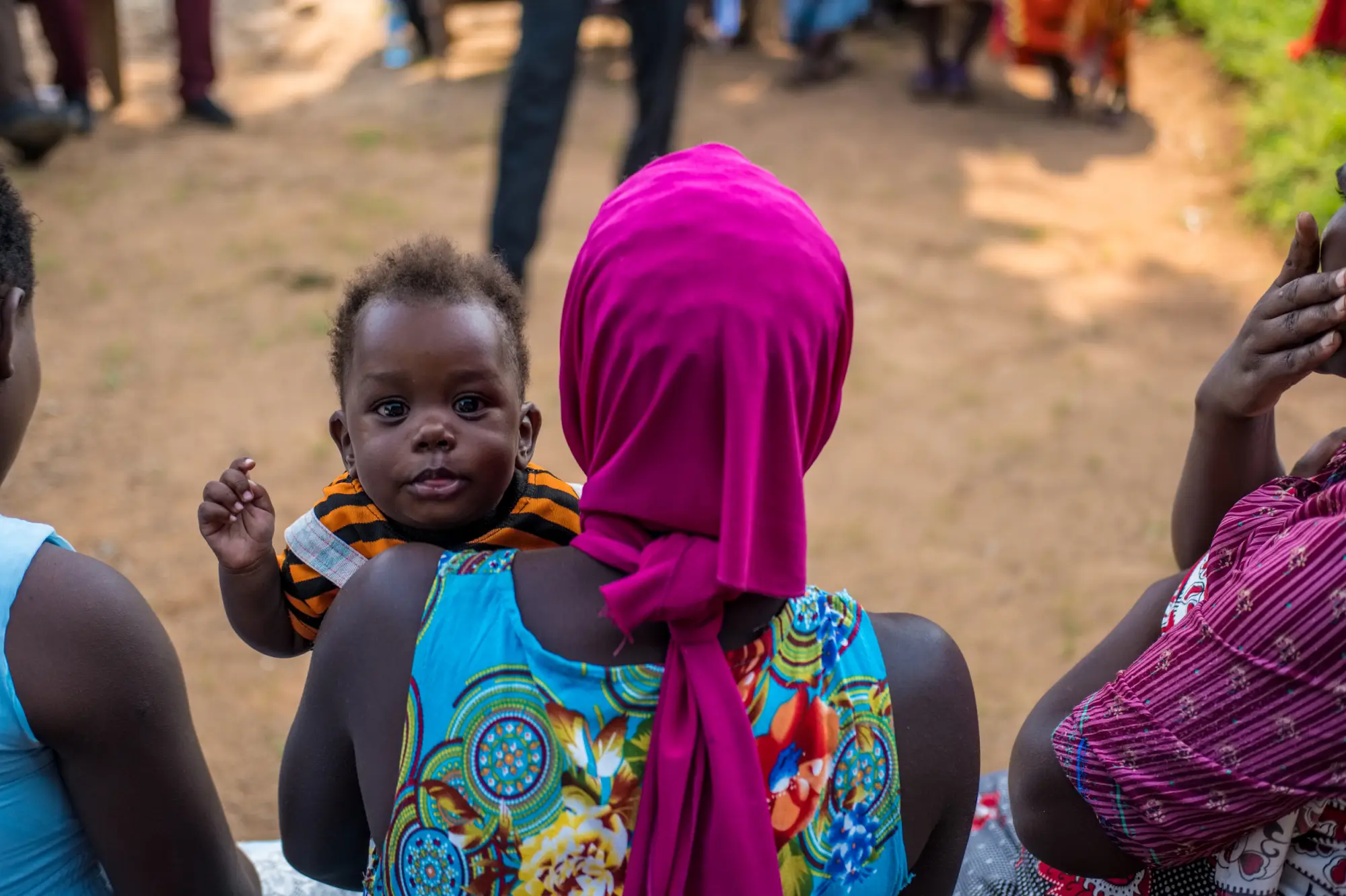 A woman holds a child in Masaka, Uganda