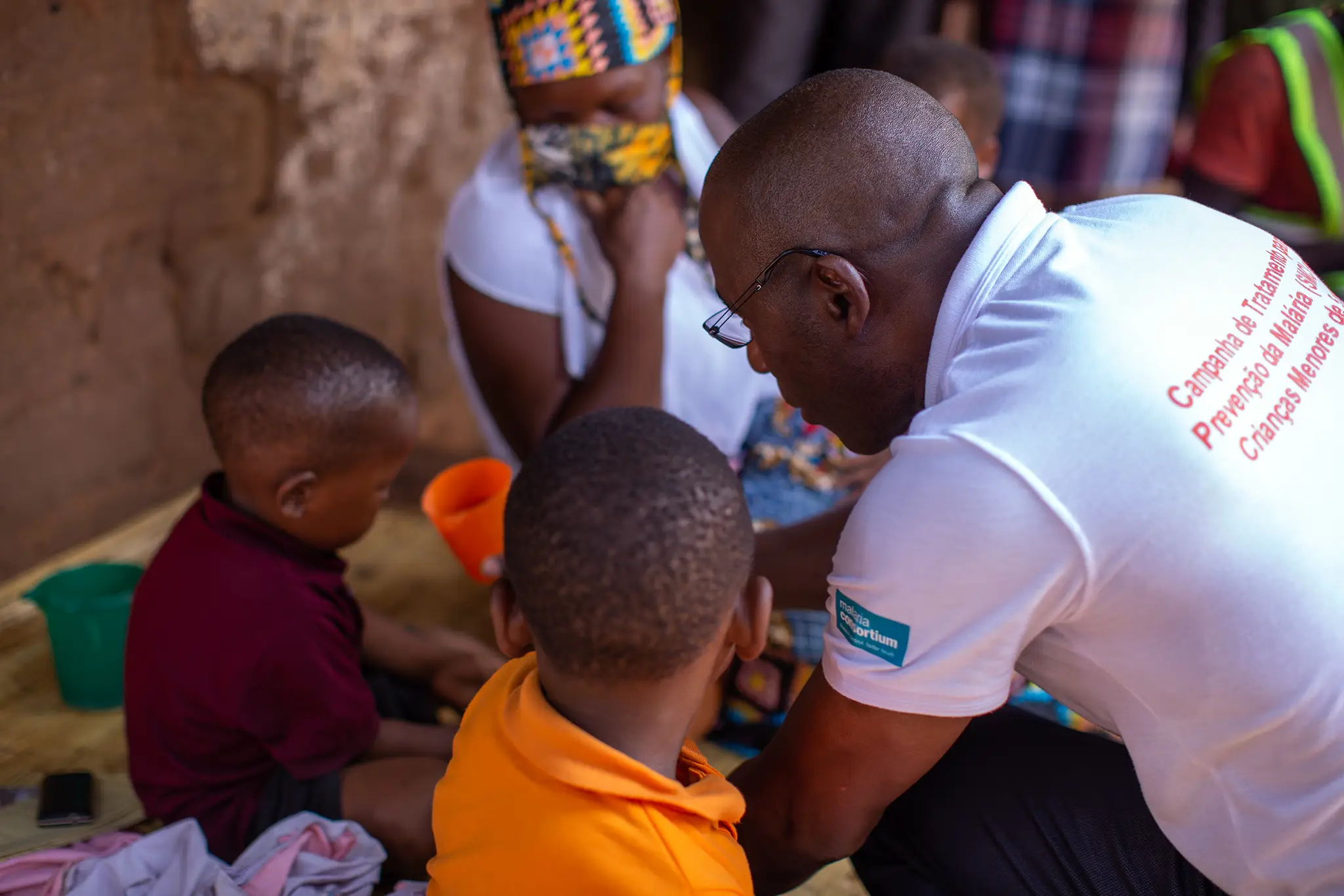 A community worker gives medicine to a child at the SMC launch event in Mozambique