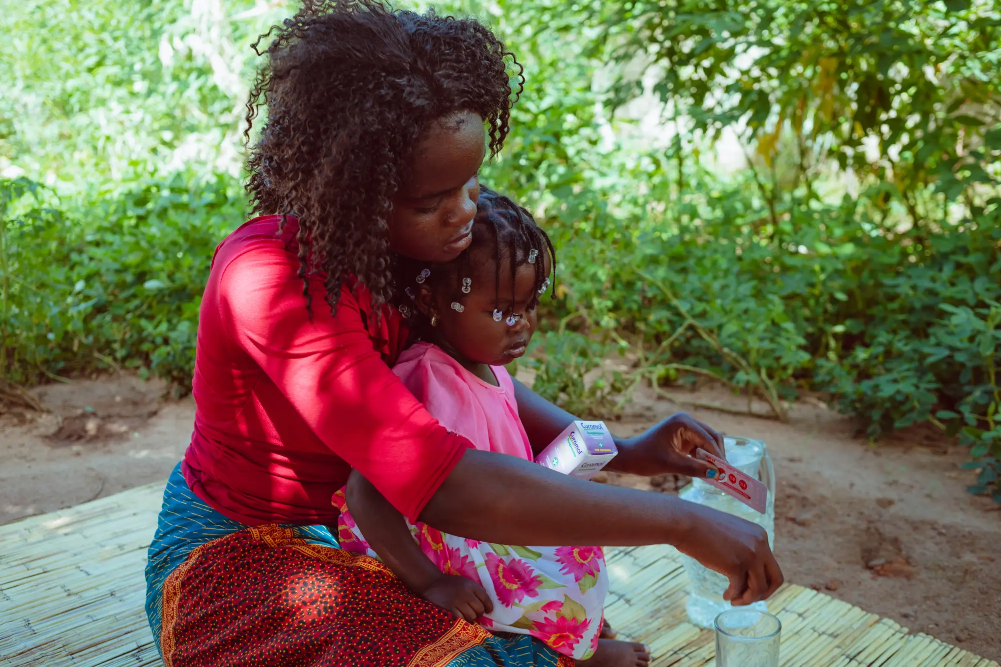 A woman prepares medicine for her child