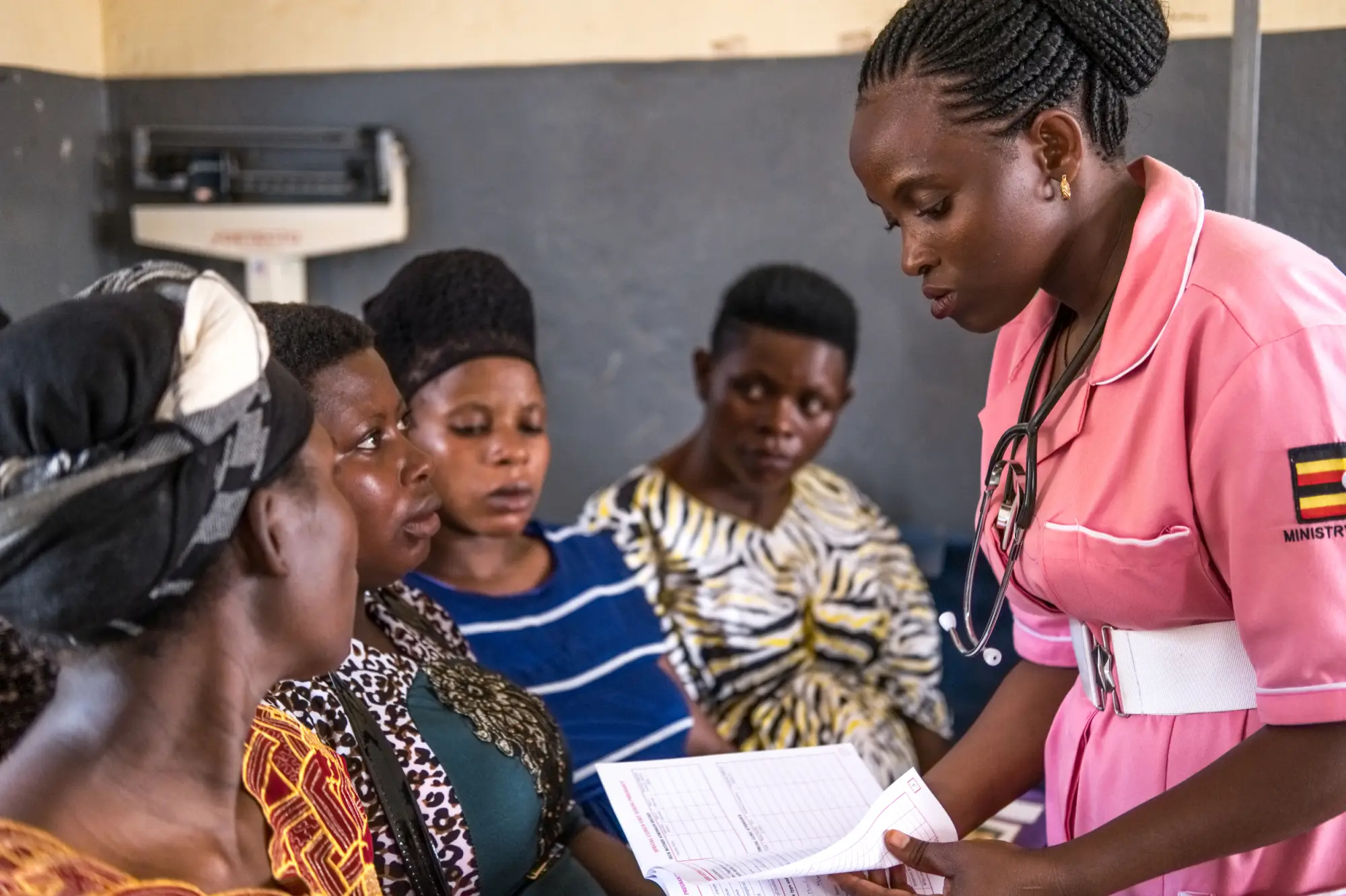 A community health worker offers advice to women in the community in Masaka, Uganda