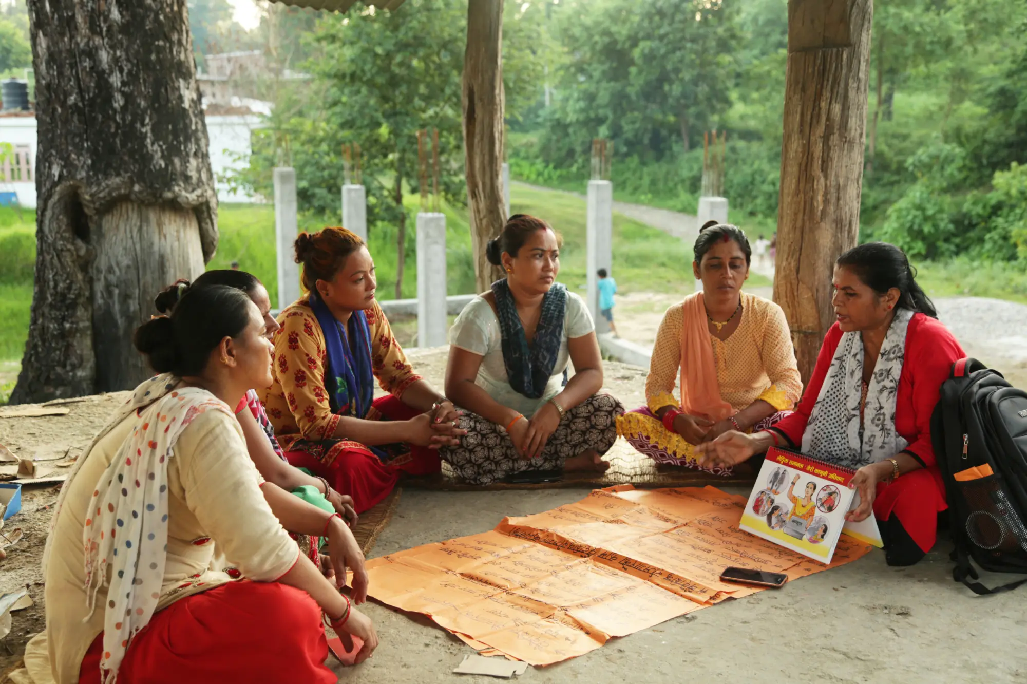 Group of women sitting around a mat