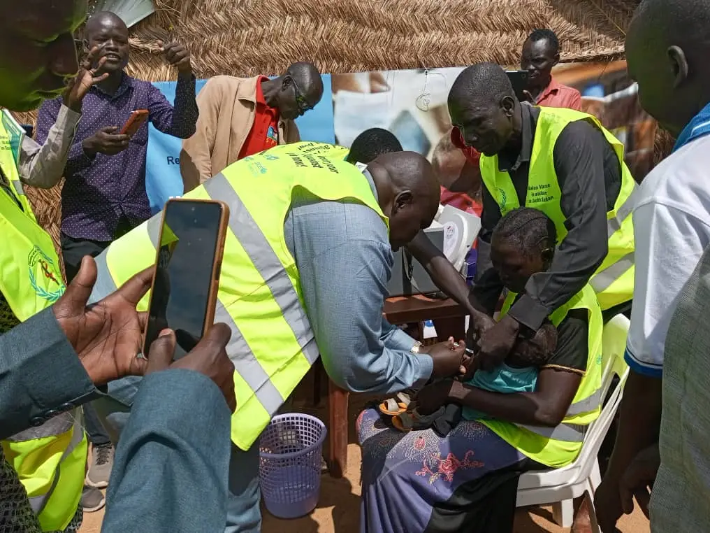 A young child receives the R21 malaria vaccine in Aweil East, from Commissioner, Diing Aher, South Sudan, July 2024