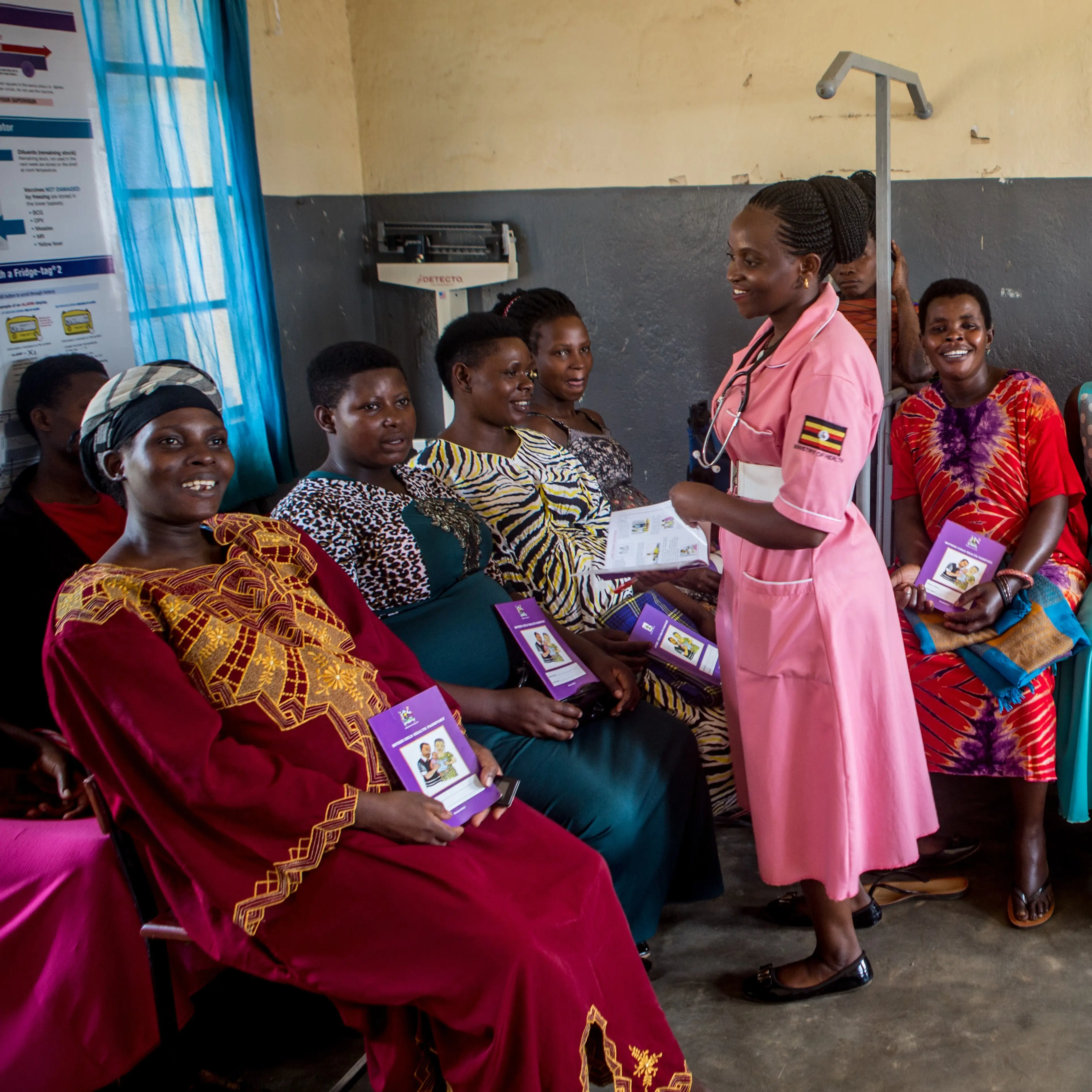 A healthcare worker talks to women in the community in Masaka, Uganda