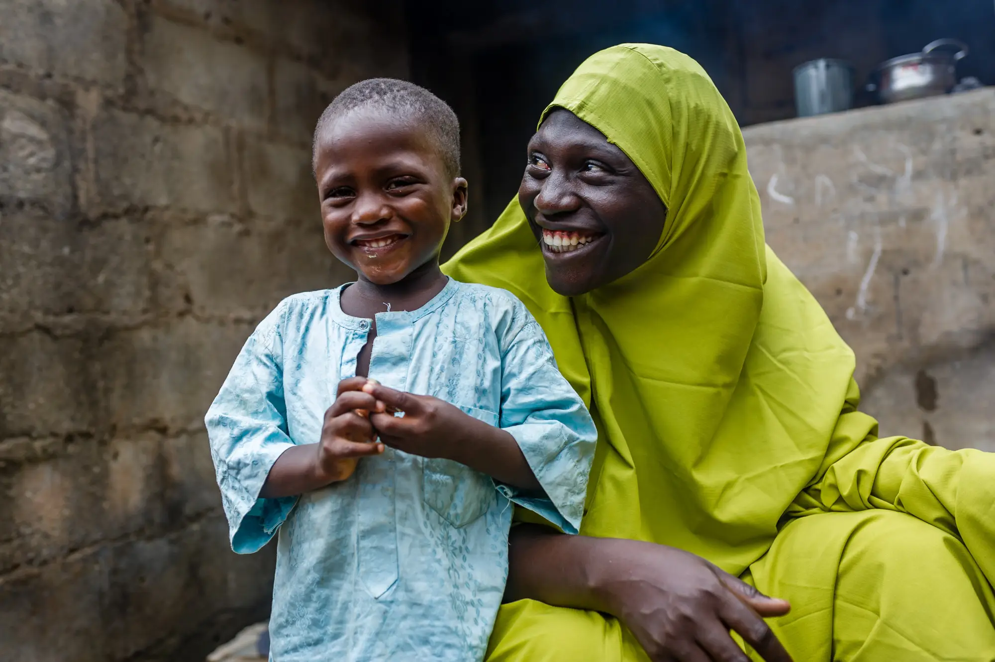 Smiling mother and child participate in the seasonal malaria chemoprevention round in Federal Capital Territory, Nigeria, 2023
