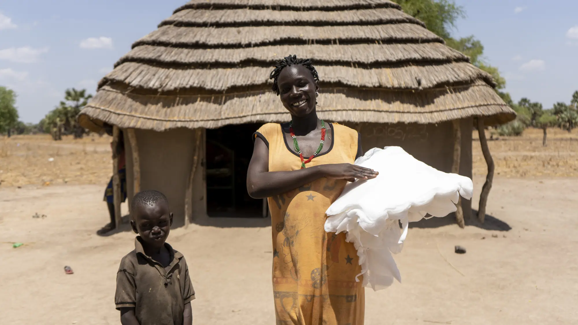 Mother of 8 receives her nets from a Malaria Consortium registrar in Aweil West, South Sudan