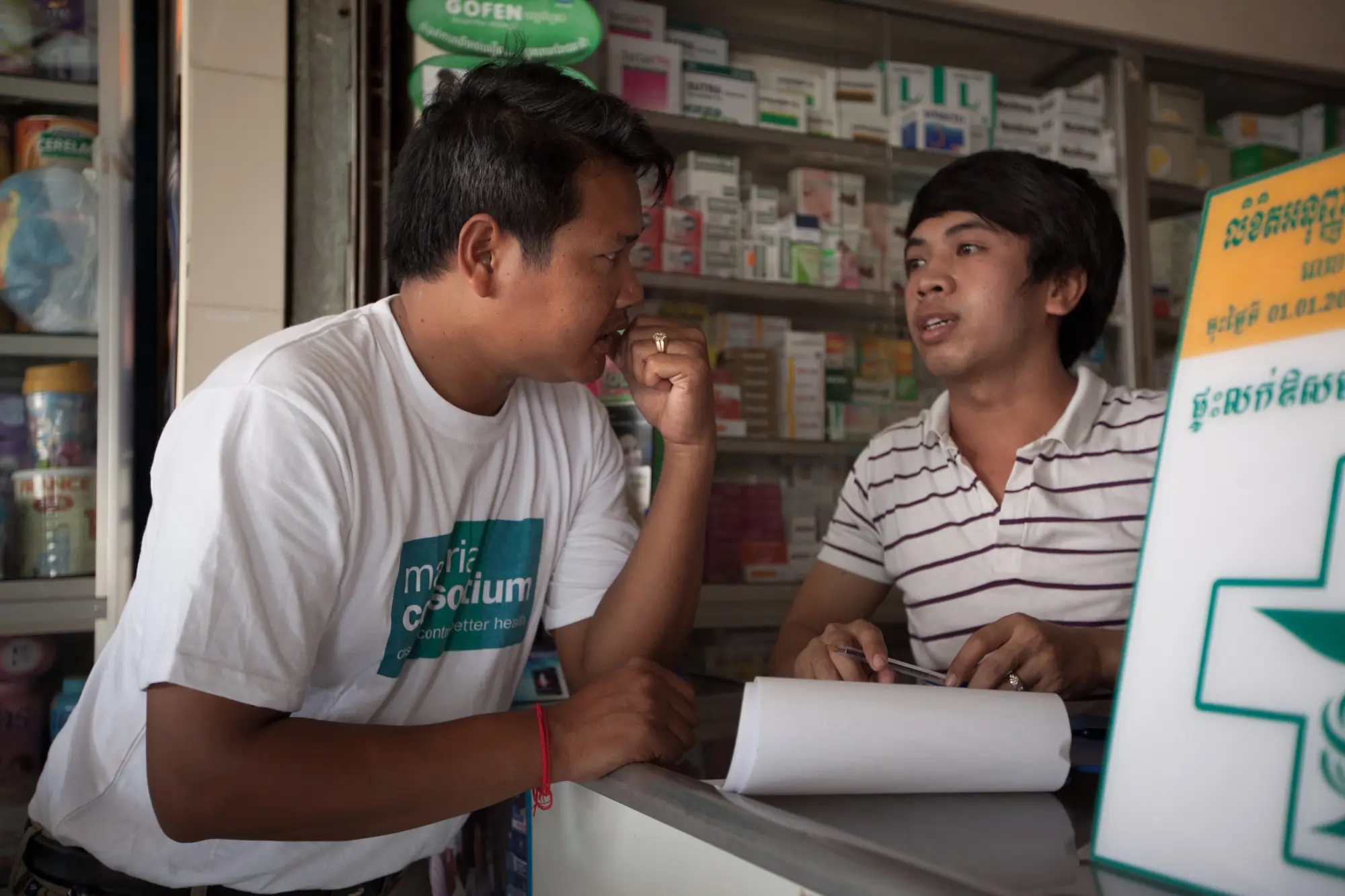 A mc staff worker talks to a local pharmacy owner about his customers and business 12433395074 o