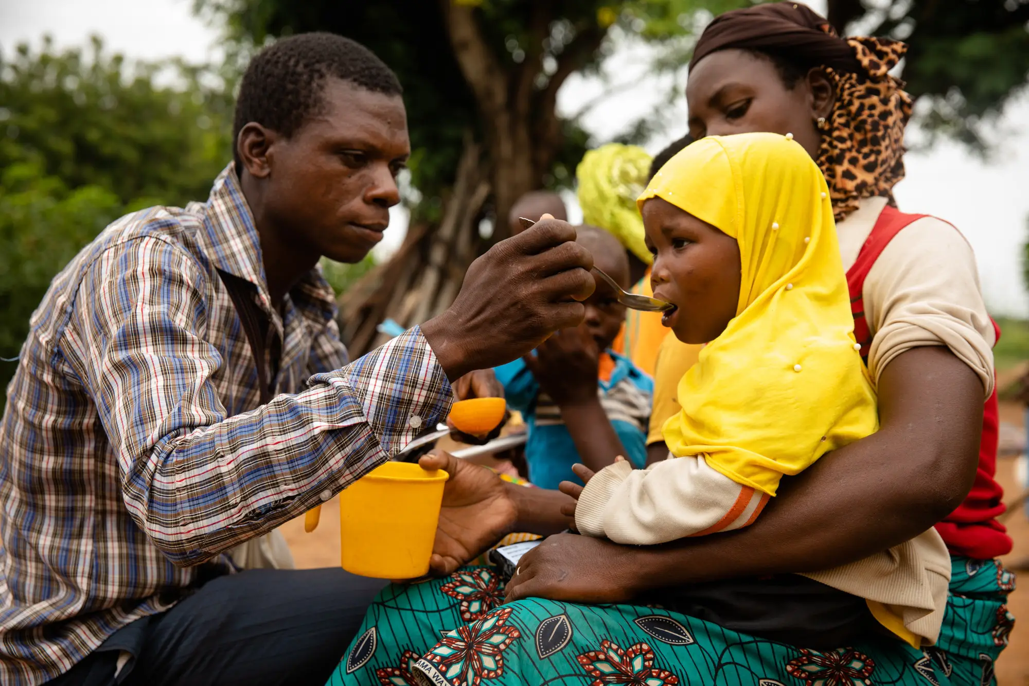 A health worker gives a child medicine.
