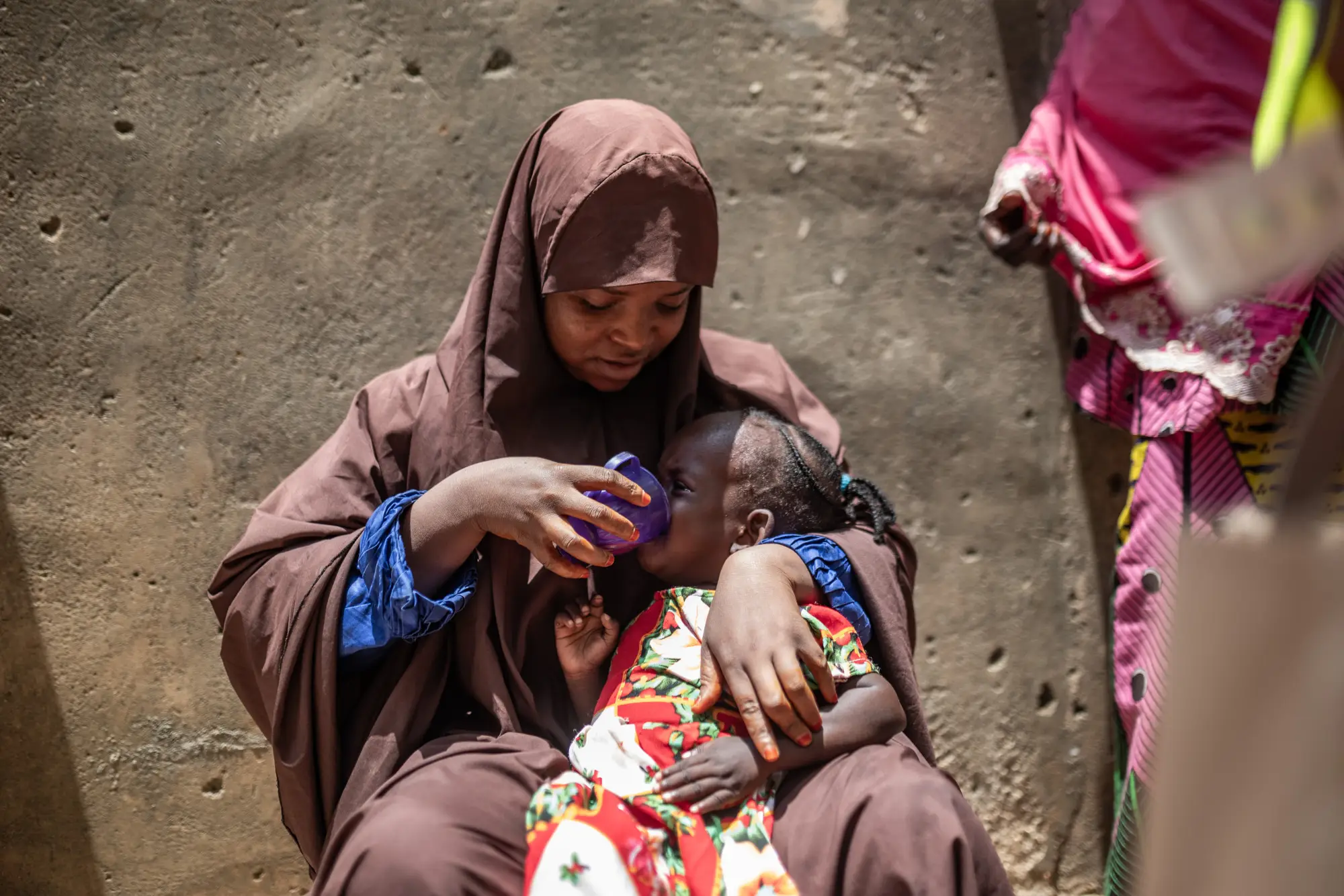 A woman gives a child SMC medicine in Kano state, Nigeria