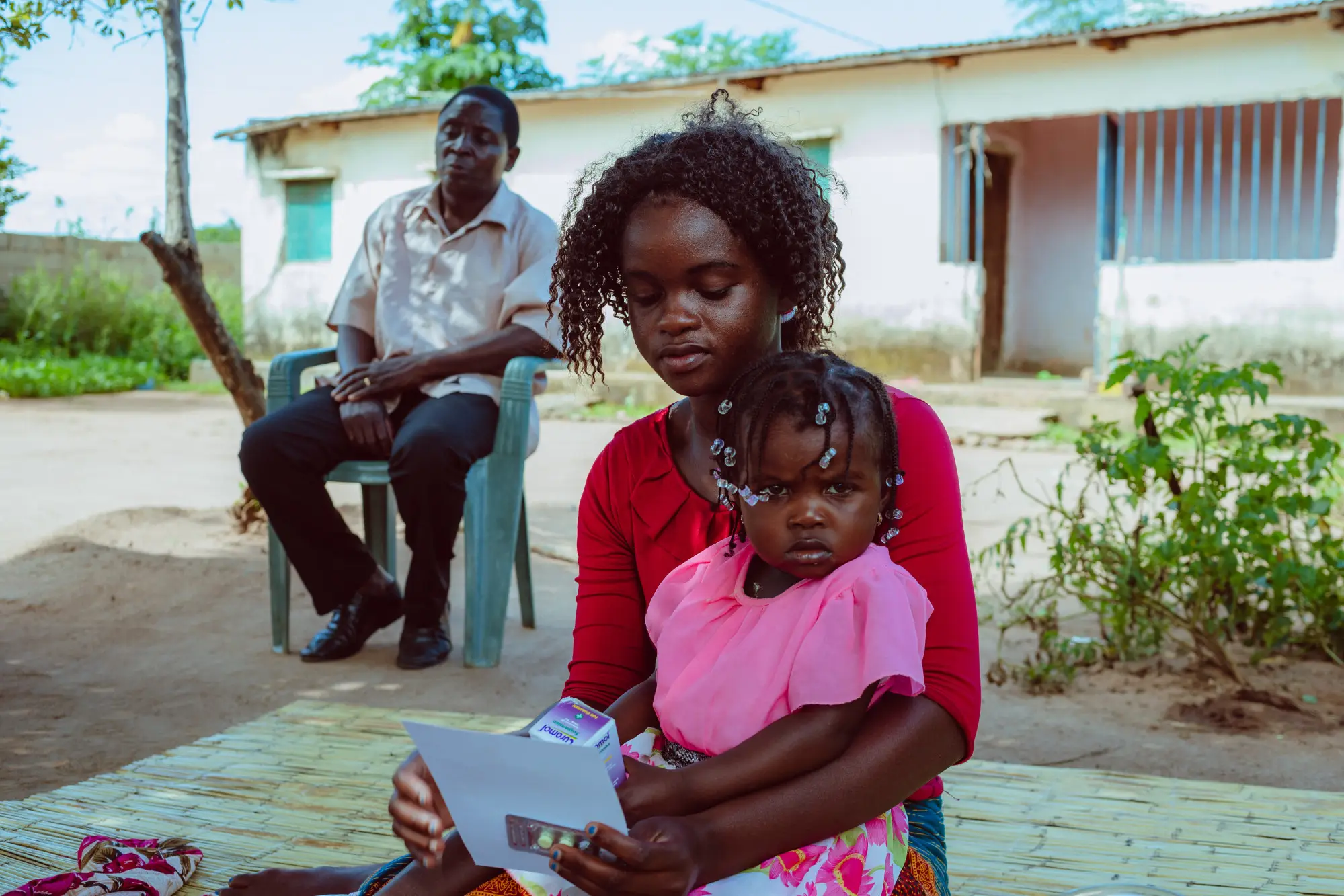 A woman sits with a child in Mozambique, 2022