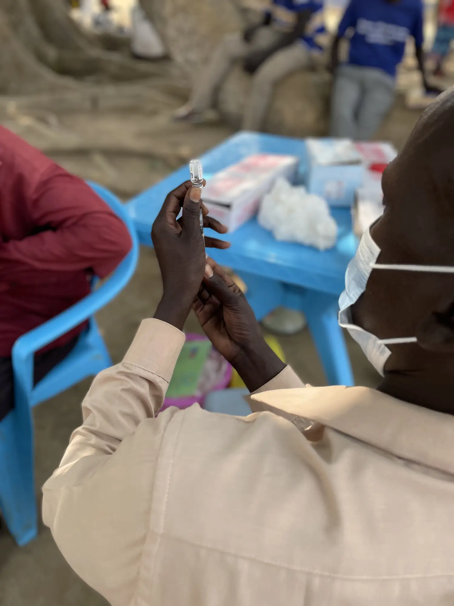 A healthcare worker prepares a vaccine in South Sudan