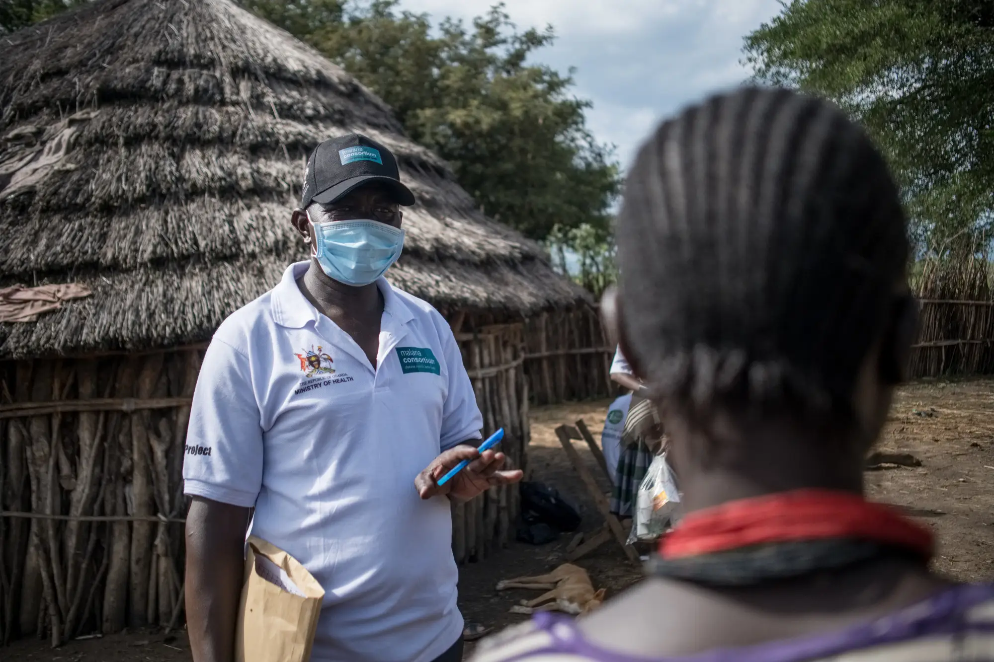 A community worker speaks to a community member in Karamoja, Uganda