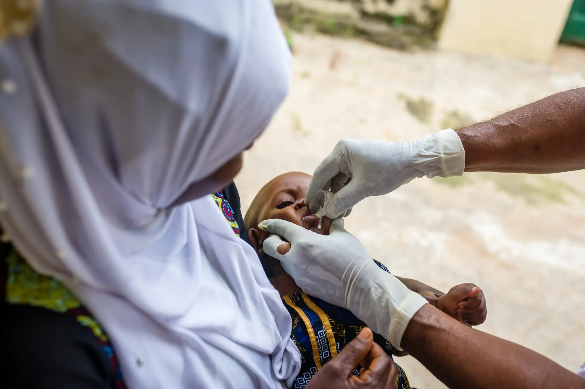 Healthcare worker administers PMC medication to infant, Osun state, Nigeria