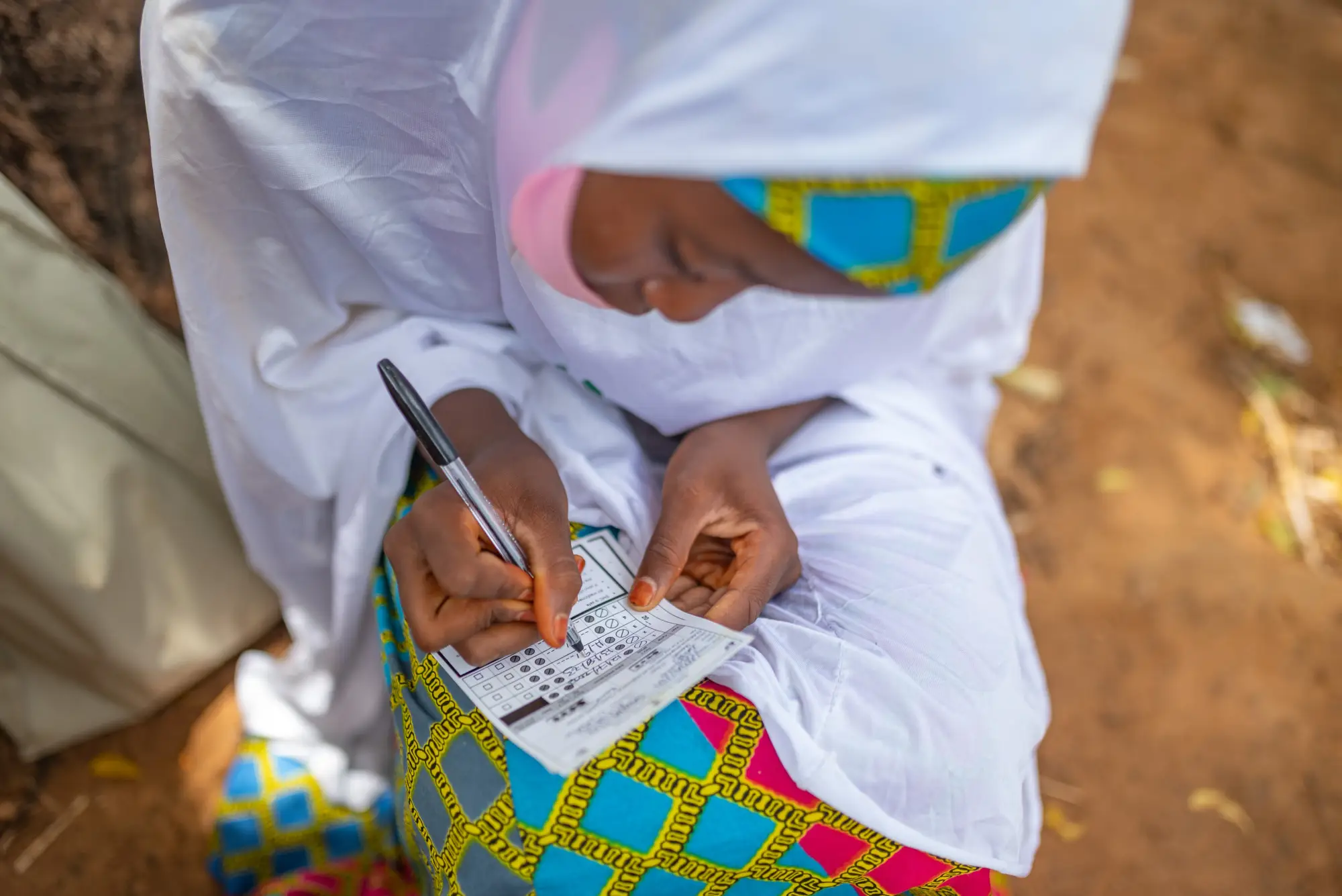 Community distributor completes paperwork for SMC medication administration, Jigawa, Nigeria.