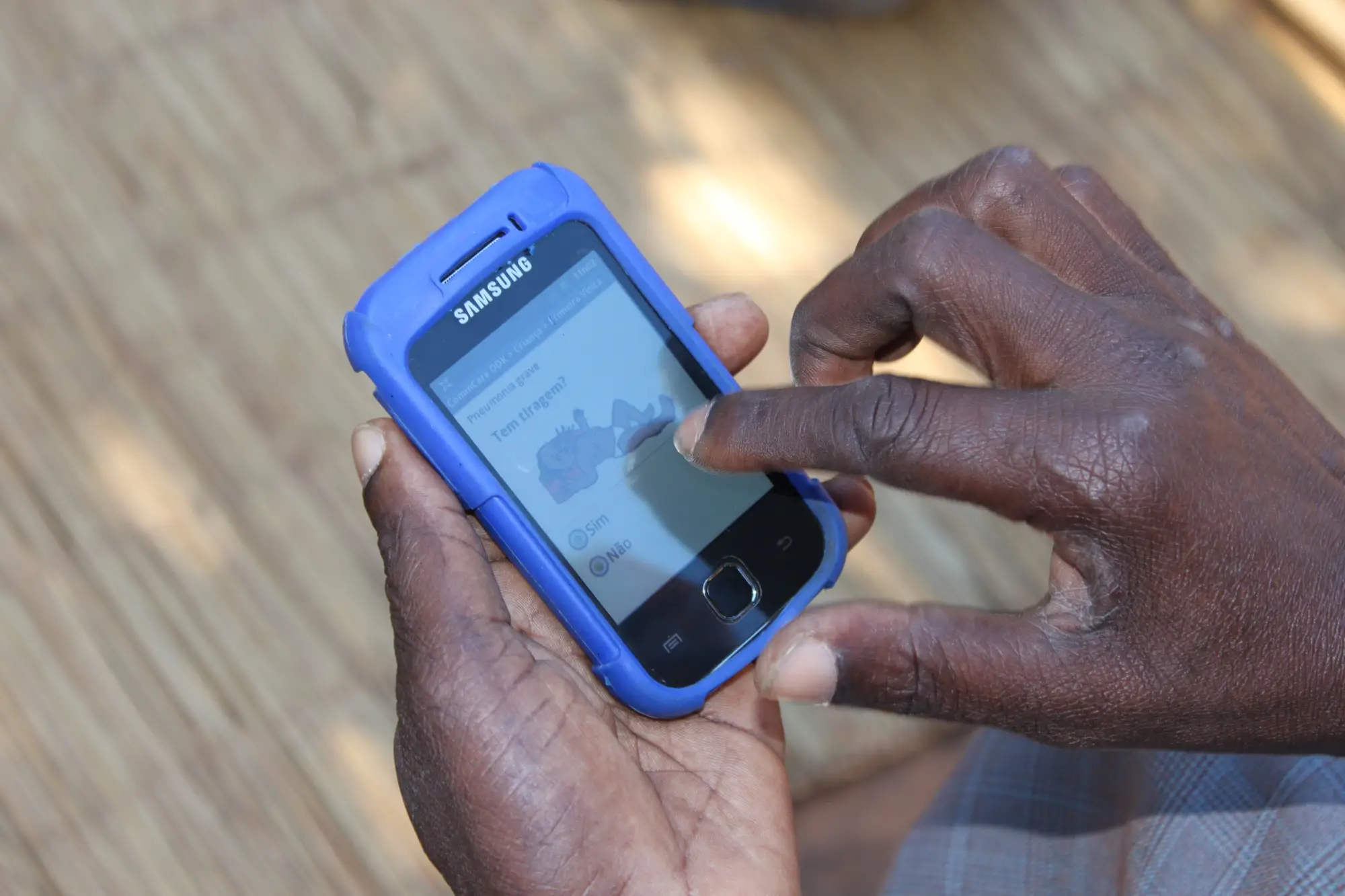 Community health worker uses the inSCALE application on their mobile device.