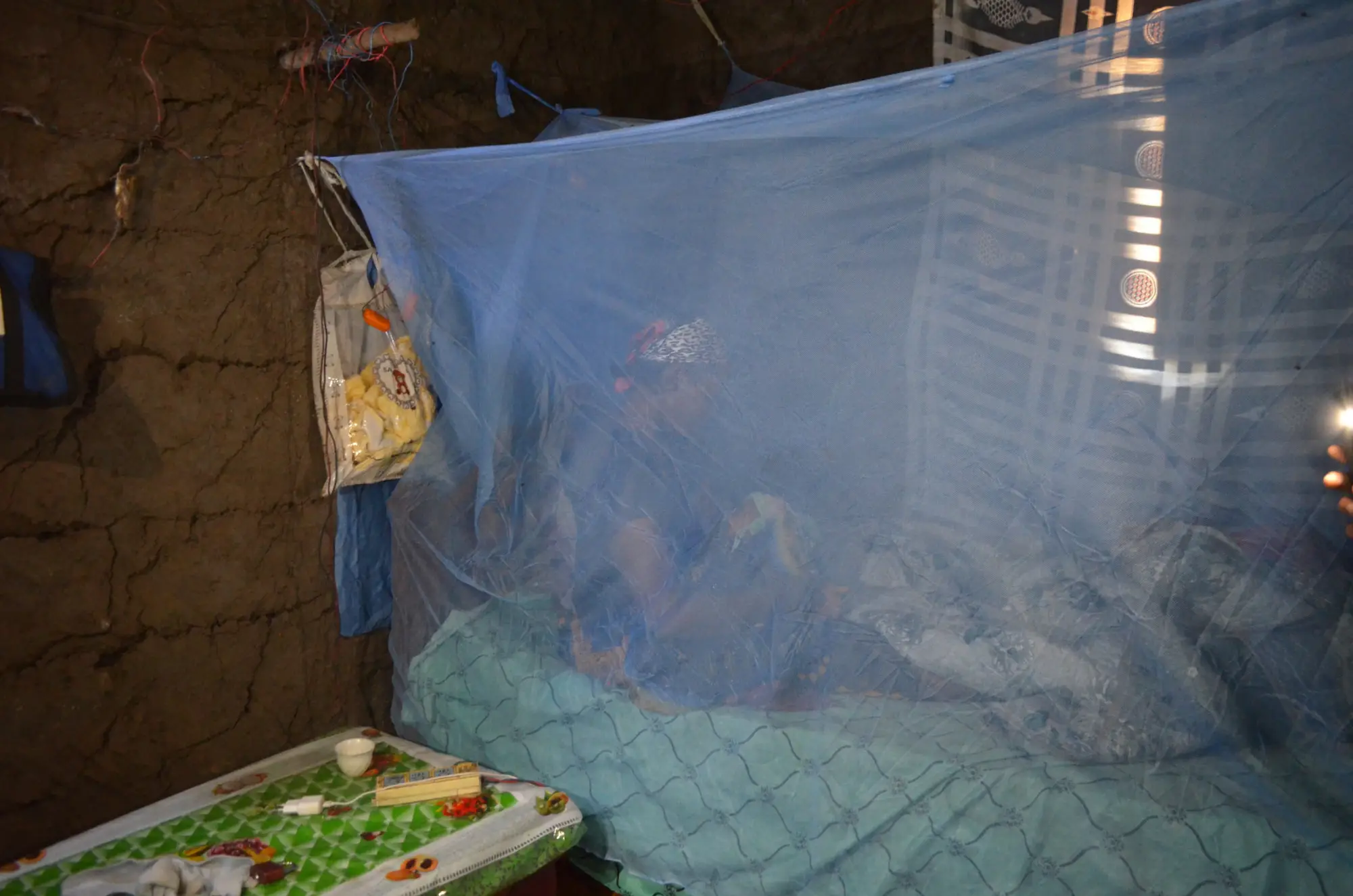 Tigist Nahom, wife of Faranko, in their house in Damot Gale village using an ITN to protect her and their child on January 30, 2026