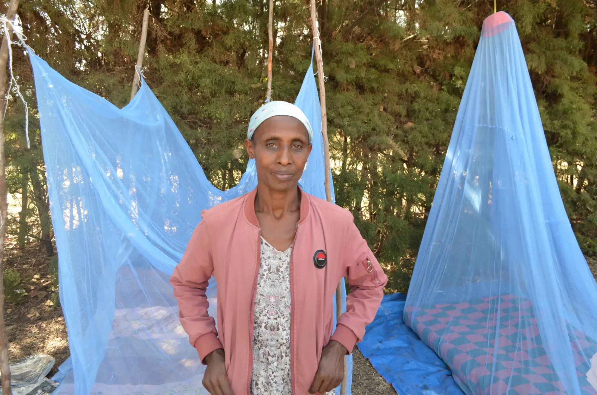 Marta Balcha, a village health leader, stands in front of a demonstration of how to use ITNs in her village of Damot Gale on January 30, 2026