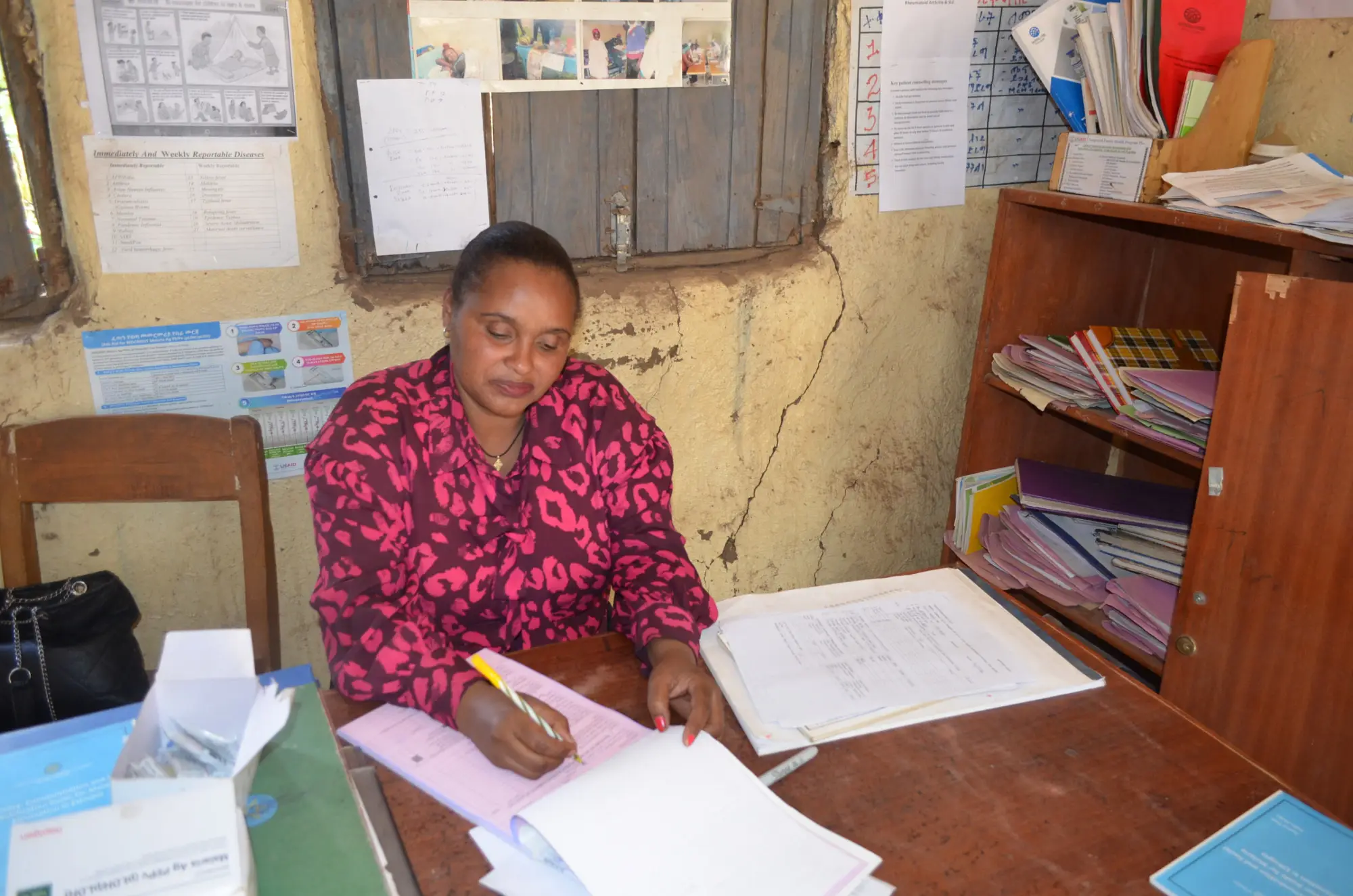 Tadelech Jembere, a health extension worker, fills out a report at the health post in Damot Gale, on January 30, 2026