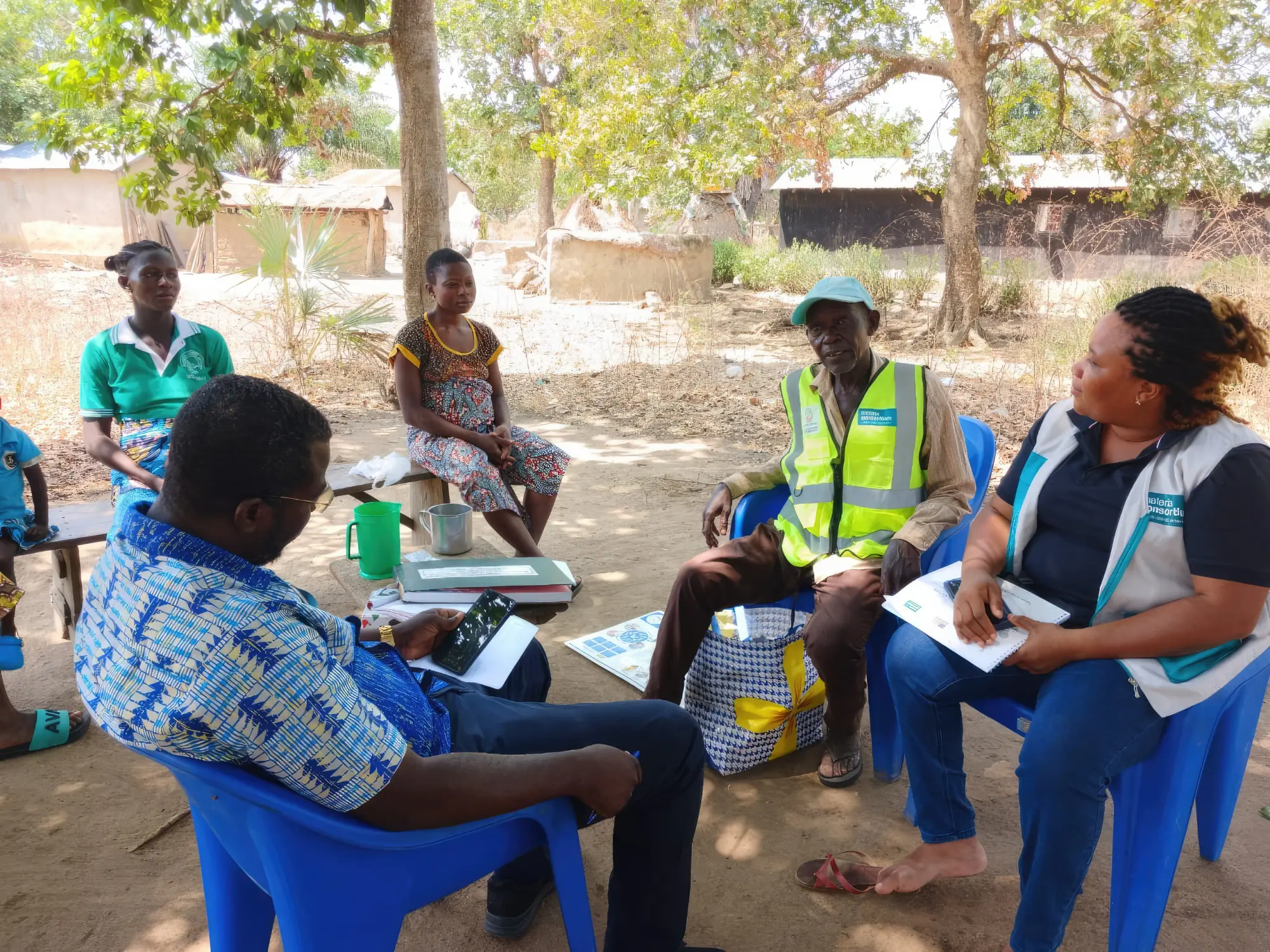 Project staff listen to feedback from pregnant women in the community on the challenges to accessing antenatal consultations, Togo.