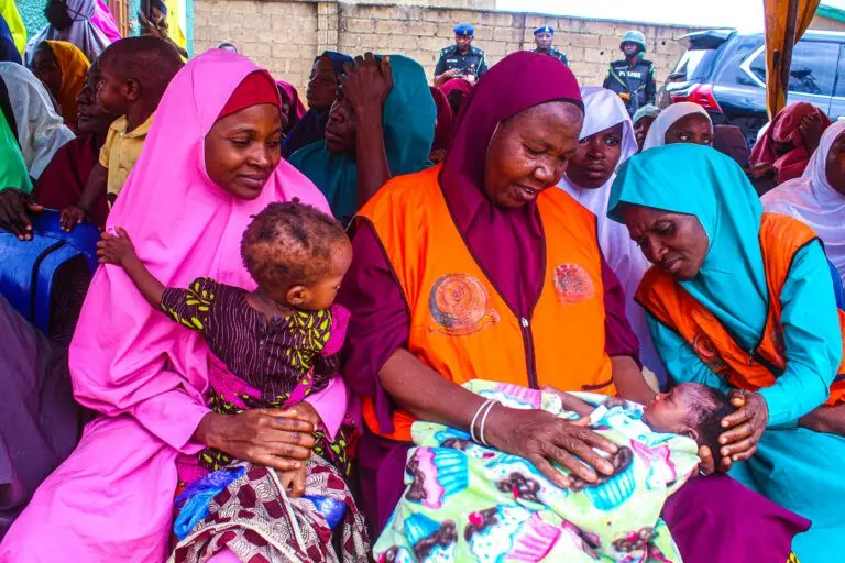 Caregivers with their children and a local health worker at the SARMAAN II campaign launch, Kaduna state, Nigeria