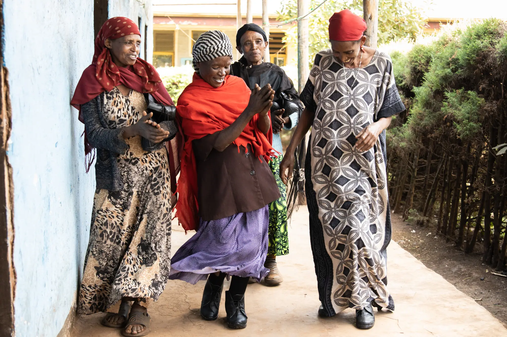 Women dancing wearing large sized shoes specially adapted to podoconiosis  patients at Sholla Kodo Health Center Youth Friendly Health Service Center, Ofa woreda, Sodo zuriya, Wolayita, Southern Ethiopia regional state