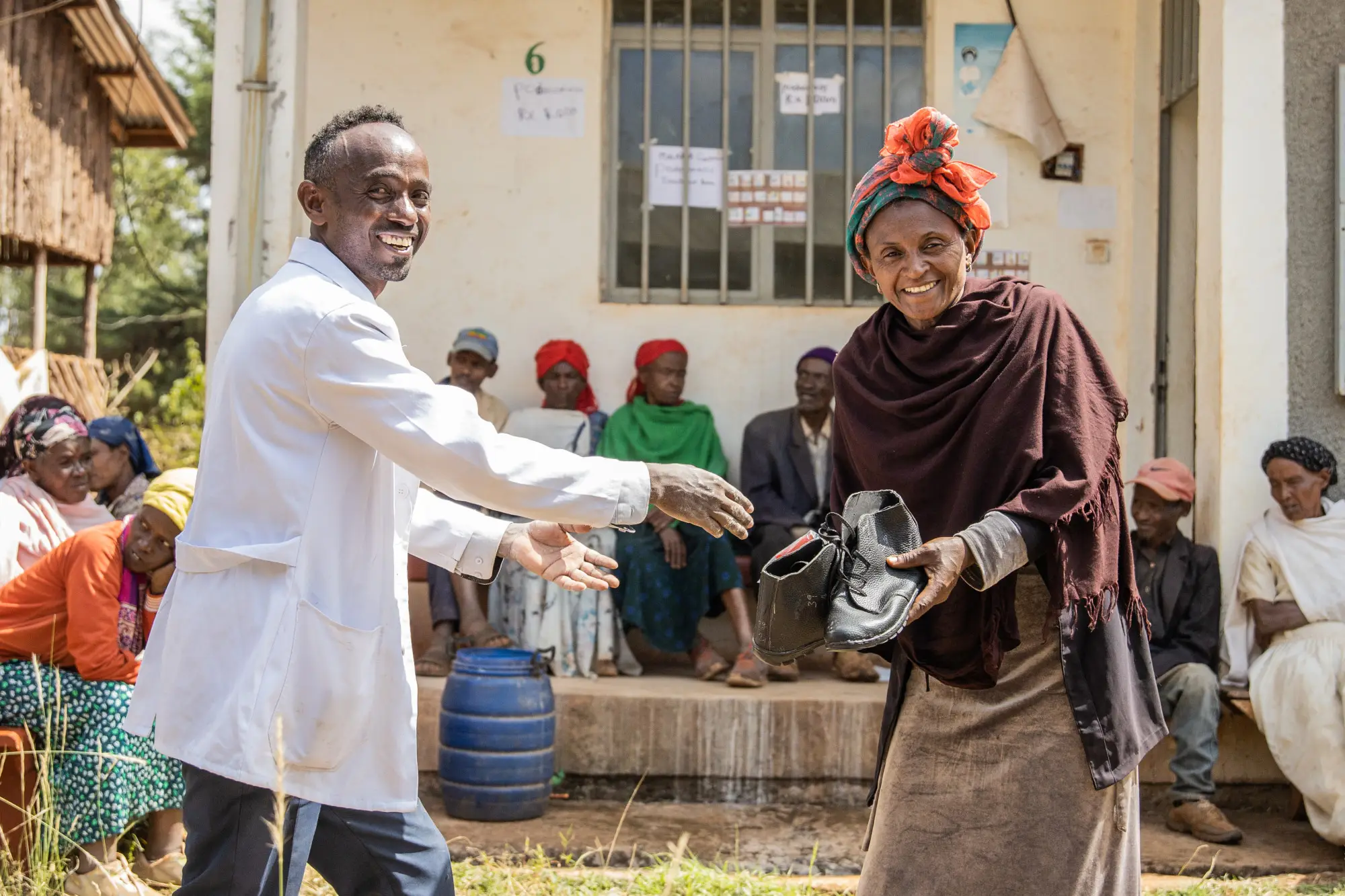 Health worker distributes large sized shoes, specially adapted to patients, at Sholla Kodo Health Center Youth Friendly Health Service Center, Ofa woreda, Sodo zuriya, Wolayita, Southern Ethiopia regional state
