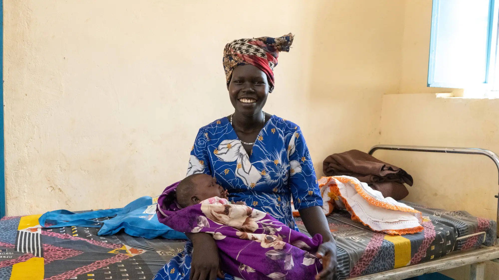 A woman holding her child in her lap