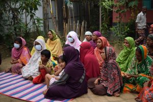 Women sit together to establish a community-wide approach for raising awareness, community mobilisation and reflection on antimicrobial resistance (AMR)