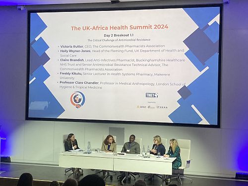 Five people sit together on a stage to discuss antimicrobial resistance (AMR) at a conference