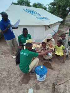 Aid workers provide resources at an IDP camp