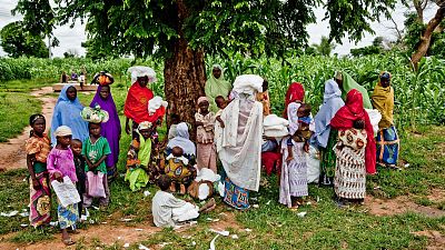 Women and children gather under a tree after collecting their LLINs from the distribution point. Young children and pregnant women are the most at risk of severe malaria. Severe malaria occurs when the infection is complicated by serious organ failures or abnormalities in the patient’s blood or metabolism. Symptoms of severe malaria can include severe anaemia, fever and convulsions, problems with breathing, extreme weakness, circulatory collapse, swollen legs, blood infection and occasionally kidney failure and coma. Even of those who have made it to hospital, around one fifth of patients die of severe malaria.