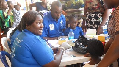 A health worker gives instructions on how to take anti-malarial drugs (ACTs) after a patient is tested positive on malaria using a rapid diagnostic test. The malaria testing was one of the side events for World Malaria Day 2015 at Jikwoi, Nigeria.