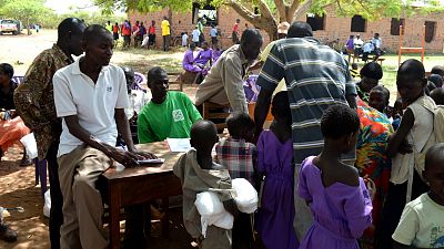 Students approach one of the tables where nets are being handed out. Once they receive the nets, their names are recorded in a register. 