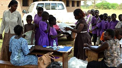 Once the distribution has begun, Malaria Consortium and teachers at the school hand out nets to students.